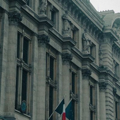 https://unsplash.com/photos/a-large-building-with-a-flag-on-top-of-it-AXvpNiPw7qY
